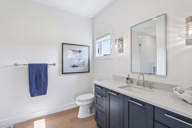 7678 Badger Run Ct, Verona, WI 53593 - full bath featuring wood finished floors, toilet, vanity, and baseboards