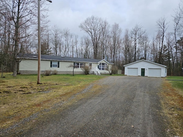 7102 Fire Tower Rd, Rhinelander, WI 54501 - view of front of house featuring an outdoor structure, a detached garage, and a front lawn