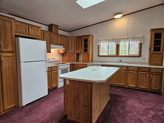 7102 Fire Tower Rd, Rhinelander, WI 54501 - kitchen featuring white appliances, under cabinet range hood, dark carpet, crown molding, and a sink