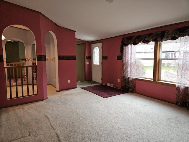 7102 Fire Tower Rd, Rhinelander, WI 54501 - entryway with carpet floors, arched walkways, and crown molding