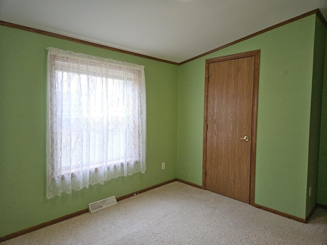 7102 Fire Tower Rd, Rhinelander, WI 54501 - unfurnished bedroom featuring ornamental molding, carpet floors, lofted ceiling, baseboards, and a closet