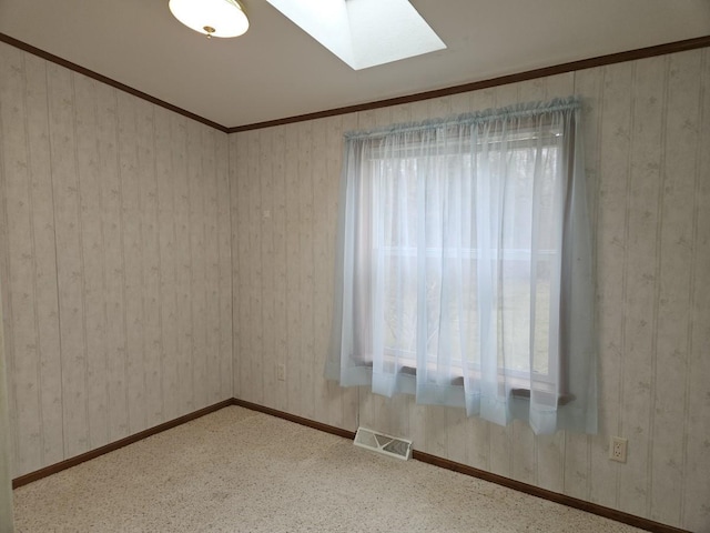 7102 Fire Tower Rd, Rhinelander, WI 54501 - unfurnished room featuring a skylight, baseboards, and crown molding