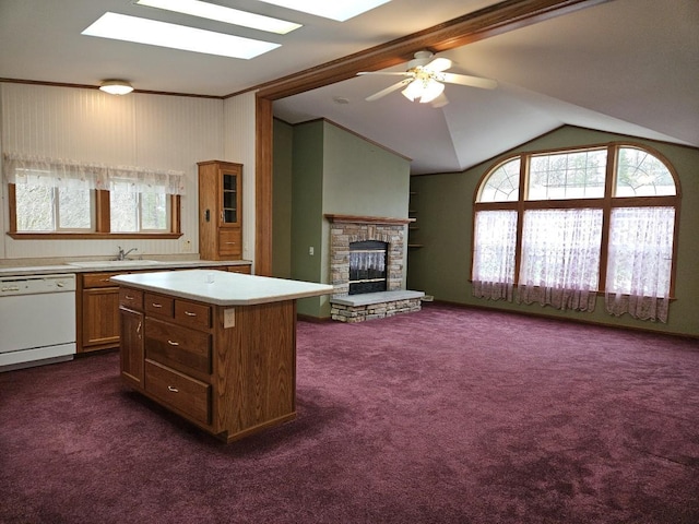 7102 Fire Tower Rd, Rhinelander, WI 54501 - kitchen with dishwasher, a sink, dark carpet, light countertops, and a skylight