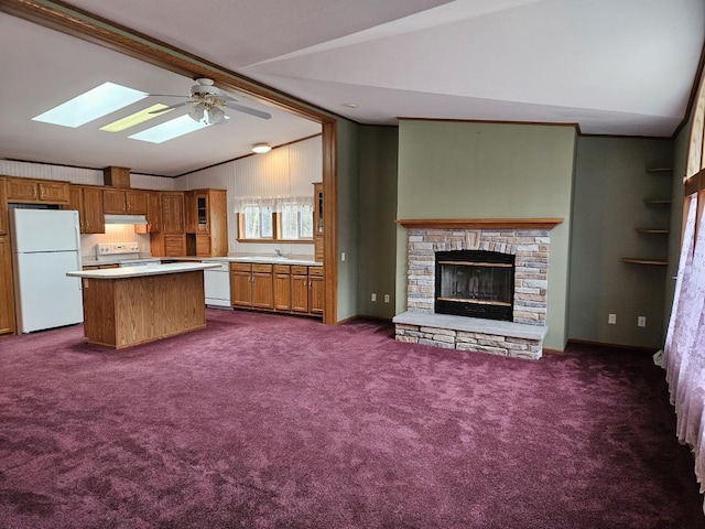 7102 Fire Tower Rd, Rhinelander, WI 54501 - kitchen with white appliances, a skylight, under cabinet range hood, vaulted ceiling, and light countertops