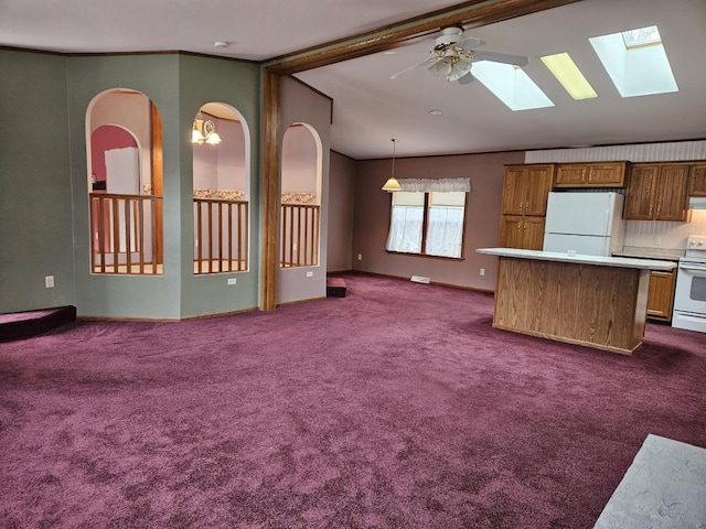 7102 Fire Tower Rd, Rhinelander, WI 54501 - unfurnished living room with lofted ceiling, a skylight, dark colored carpet, and a ceiling fan