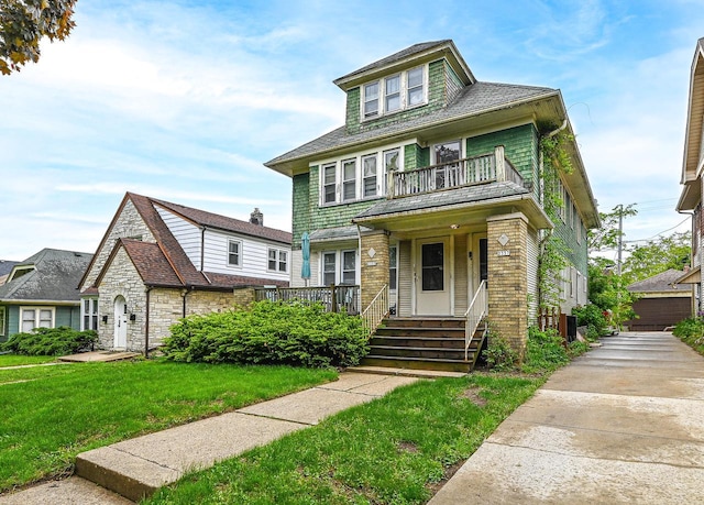 2355 N 59th St Unit 2357, Milwaukee, WI 53210 - american foursquare style home featuring a balcony, a front lawn, covered porch, and a shingled roof