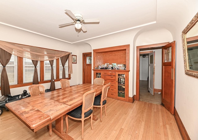 2355 N 59th St Unit 2357, Milwaukee, WI 53210 - dining area with light wood-type flooring, a ceiling fan, baseboards, arched walkways, and a dry bar