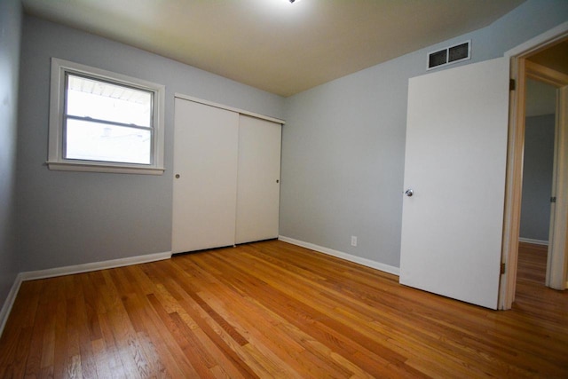 7928 W Clovernook St, Milwaukee, WI 53223 - unfurnished bedroom featuring light wood finished floors, baseboards, and a closet