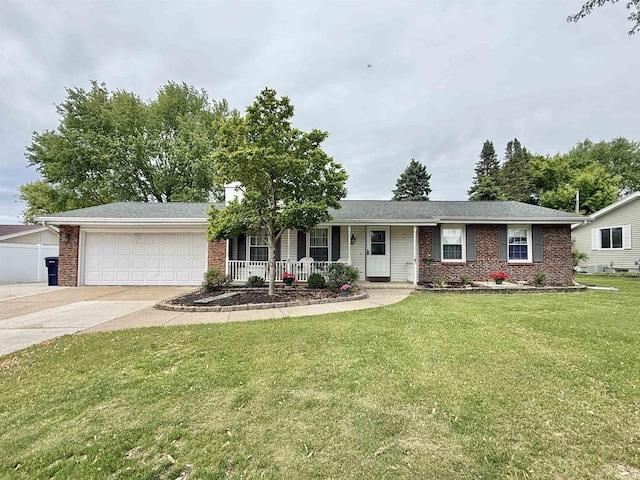 3117 Canterbury Ln, Janesville, WI 53546 - single story home featuring brick siding, a garage, a porch, a front lawn, and driveway