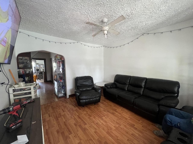 1451 S Union St, Milwaukee, WI 53204 - living room featuring ceiling fan, a textured ceiling, wood finished floors, and arched walkways