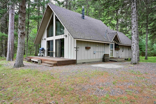 2775 Lake Rd, Barnes, WI 54873 - rear view of house featuring roof with shingles, a deck, and board and batten siding