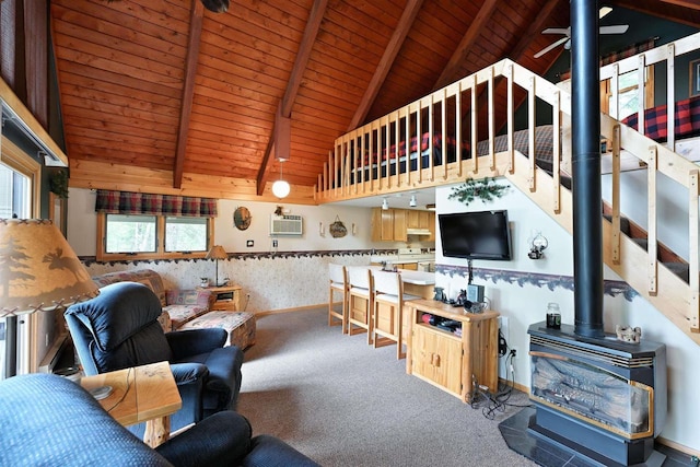 2775 Lake Rd, Barnes, WI 54873 - living room with a wood stove, wood ceiling, carpet flooring, a wall mounted air conditioner, and baseboards
