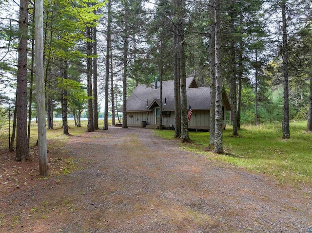 2775 Lake Rd, Barnes, WI 54873 - rustic home with roof with shingles, dirt driveway, and board and batten siding