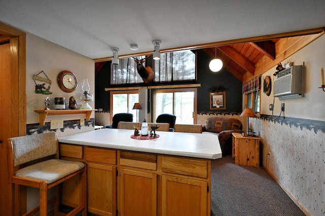 2775 Lake Rd, Barnes, WI 54873 - kitchen featuring open floor plan, a peninsula, carpet flooring, an AC wall unit, and light countertops