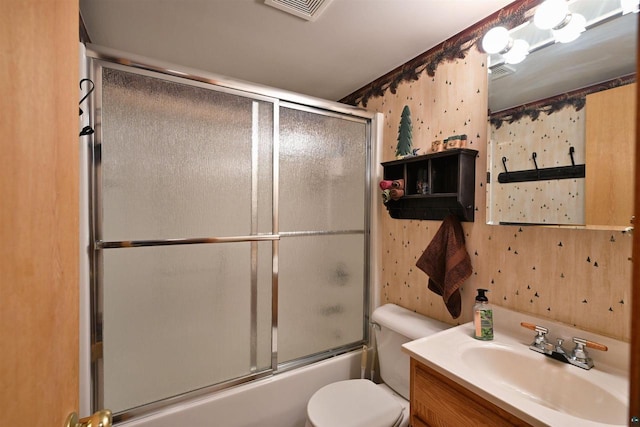 2775 Lake Rd, Barnes, WI 54873 - bathroom featuring vanity, toilet, and combined bath / shower with glass door