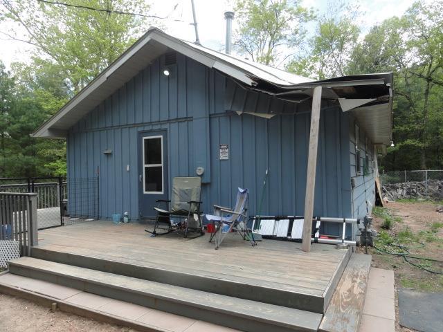 W4643 S Pearl Lake Rd, Redgranite, WI 54970 - back of property with board and batten siding and a deck