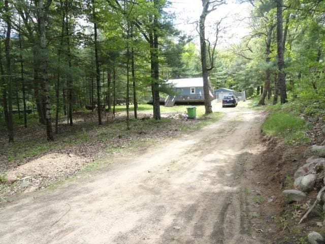 W4643 S Pearl Lake Rd, Redgranite, WI 54970 - view of dirt / gravel driveway with a view of trees