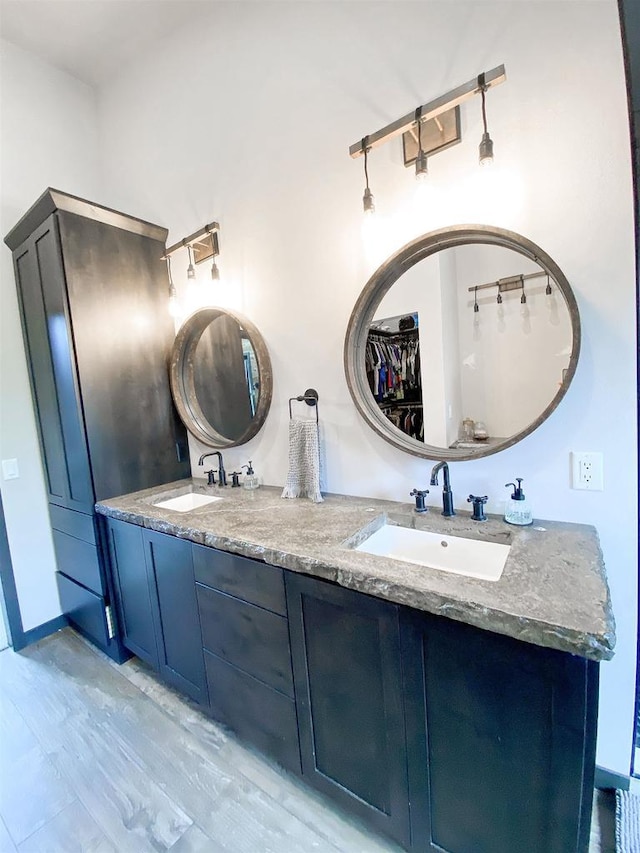 S7915 Ruthe Badger Ln, Merrimac, WI 53561 - full bathroom with double vanity and wood finished floors