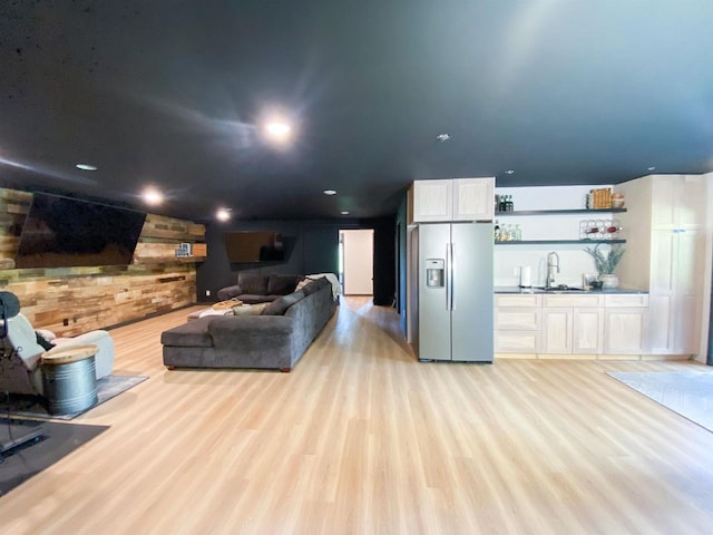 S7915 Ruthe Badger Ln, Merrimac, WI 53561 - living area featuring light wood finished floors, wood walls, and wet bar
