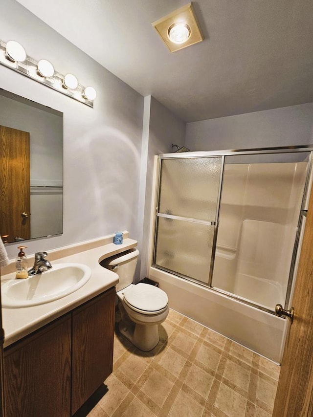 1114 W St, Racine, WI 53404 - bathroom featuring toilet, vanity, bath / shower combo with glass door, and tile patterned floors