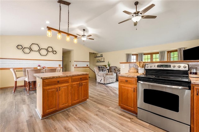 4868 183rd St, Chippewa Falls, WI 54729 - kitchen featuring electric range, ceiling fan, vaulted ceiling, brown cabinetry, and light countertops
