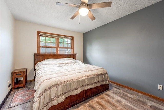 4868 183rd St, Chippewa Falls, WI 54729 - bedroom with wood finished floors, baseboards, a ceiling fan, and a textured ceiling