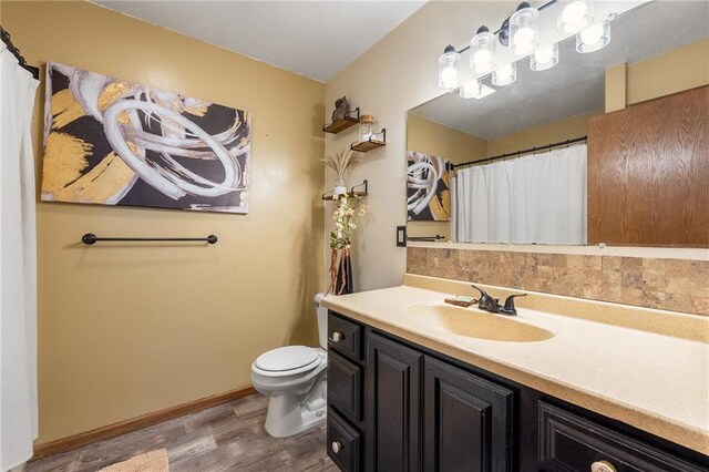 4868 183rd St, Chippewa Falls, WI 54729 - full bathroom featuring wood finished floors, vanity, toilet, and baseboards