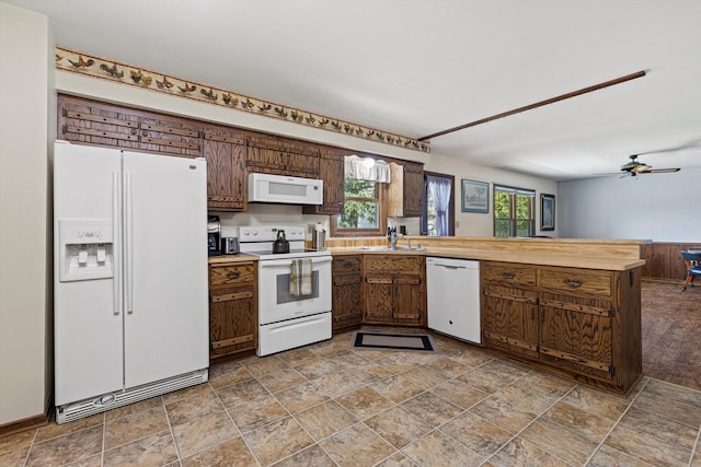 1517 Merry Ct, Port Washington, WI 53074 - kitchen featuring white appliances, a sink, a peninsula, and stone finish flooring