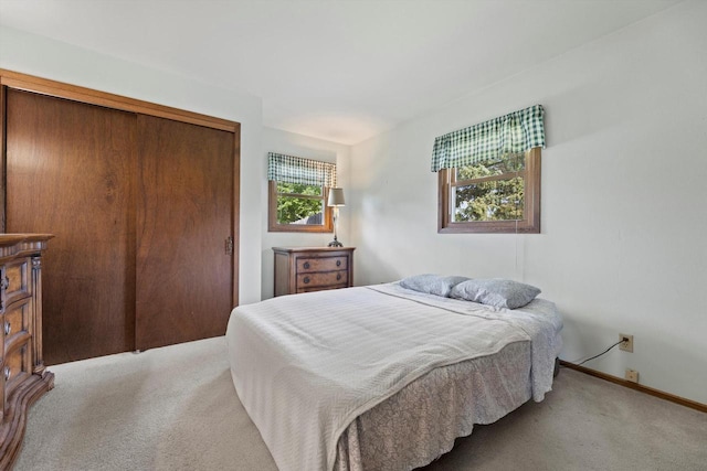 1517 Merry Ct, Port Washington, WI 53074 - bedroom with carpet flooring, a closet, and baseboards