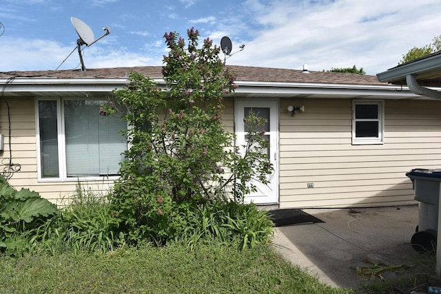 6655 N 78th St, Milwaukee, WI 53223 - view of home's exterior with a patio area and roof with shingles