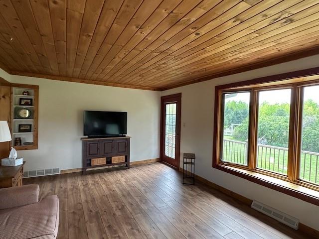12258 Mosquito Brook Rd, Hayward, WI 54843 - unfurnished living room featuring ornamental molding, wooden ceiling, baseboards, and wood-type flooring