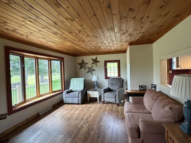 12258 Mosquito Brook Rd, Hayward, WI 54843 - sitting room featuring wooden ceiling, crown molding, and hardwood / wood-style flooring