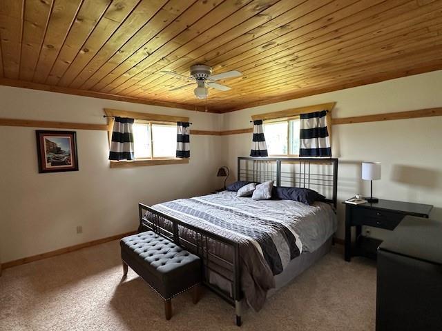 12258 Mosquito Brook Rd, Hayward, WI 54843 - carpeted bedroom featuring wooden ceiling, baseboards, and ceiling fan