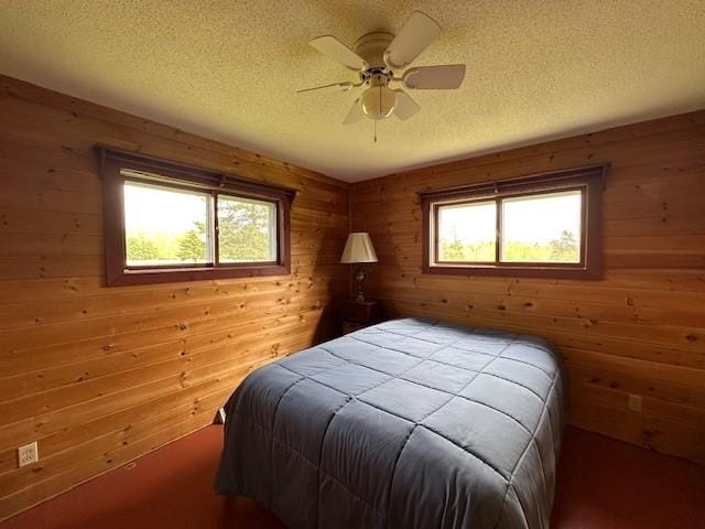 12258 Mosquito Brook Rd, Hayward, WI 54843 - bedroom with a textured ceiling, wooden walls, and a ceiling fan