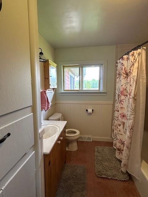 12258 Mosquito Brook Rd, Hayward, WI 54843 - bathroom with vanity, wainscoting, toilet, shower / tub combo with curtain, and tile patterned floors