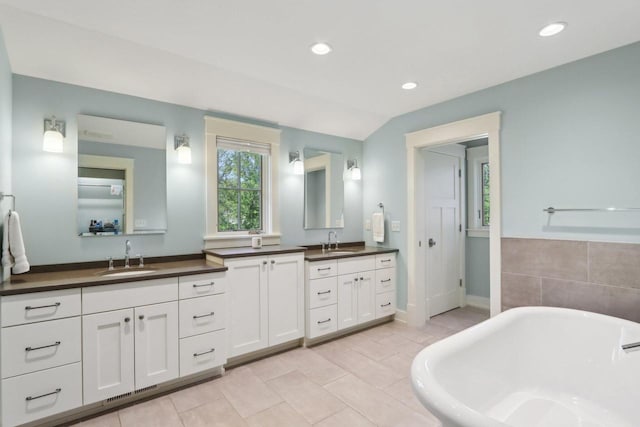 S36W27905 Robin Hill Cir, Waukesha, WI 53189 - bathroom with a freestanding tub, double vanity, recessed lighting, tile patterned flooring, and baseboards