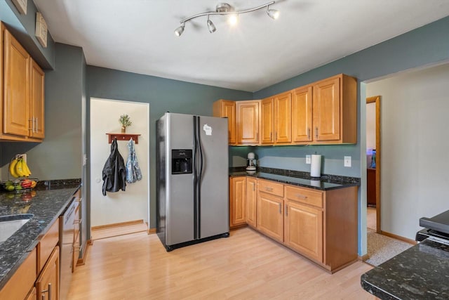 1017 S 120th St, West Allis, WI 53214 - kitchen featuring appliances with stainless steel finishes, light wood-style flooring, dark stone countertops, and baseboards