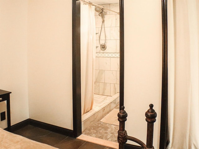 507 Janesville St, Oregon, WI 53575 - bathroom with tiled shower, baseboards, and tile patterned floors