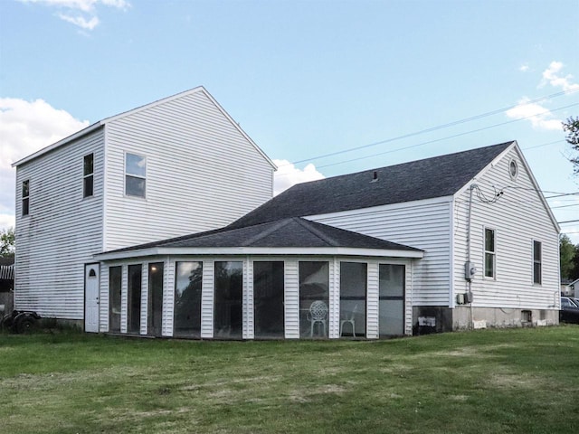 507 Janesville St, Oregon, WI 53575 - rear view of property featuring a sunroom, a lawn, and roof with shingles