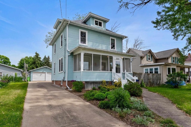 210 Gilmore Ave, Beaver Dam, WI 53916 - traditional style home with an outdoor structure, a sunroom, and a detached garage