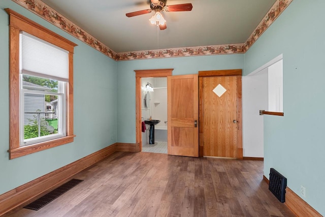210 Gilmore Ave, Beaver Dam, WI 53916 - entryway featuring wood finished floors, a ceiling fan, and baseboards