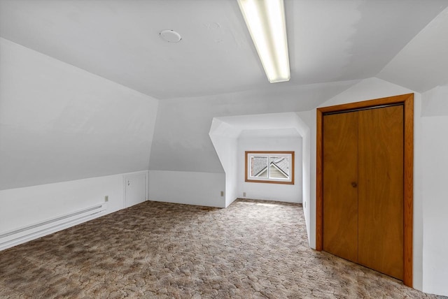 210 Gilmore Ave, Beaver Dam, WI 53916 - additional living space with vaulted ceiling, carpet floors, and a baseboard radiator