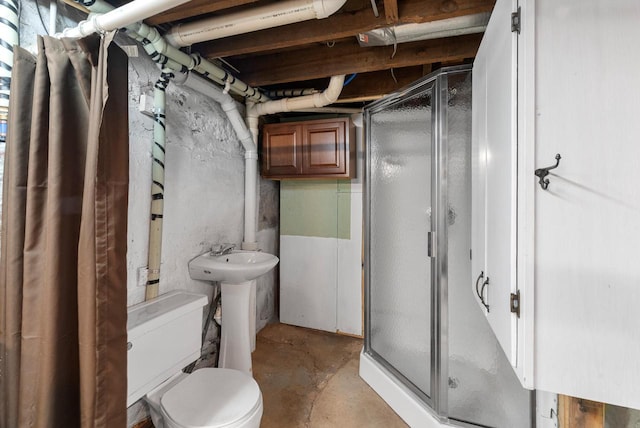 210 Gilmore Ave, Beaver Dam, WI 53916 - full bath featuring a shower stall, concrete flooring, toilet, and a sink