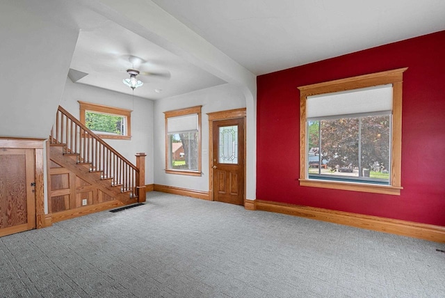 210 Gilmore Ave, Beaver Dam, WI 53916 - carpeted entryway featuring plenty of natural light, baseboards, and stairway