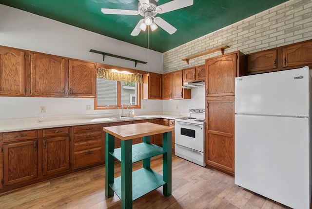 210 Gilmore Ave, Beaver Dam, WI 53916 - kitchen with white appliances, a sink, under cabinet range hood, and light wood-type flooring