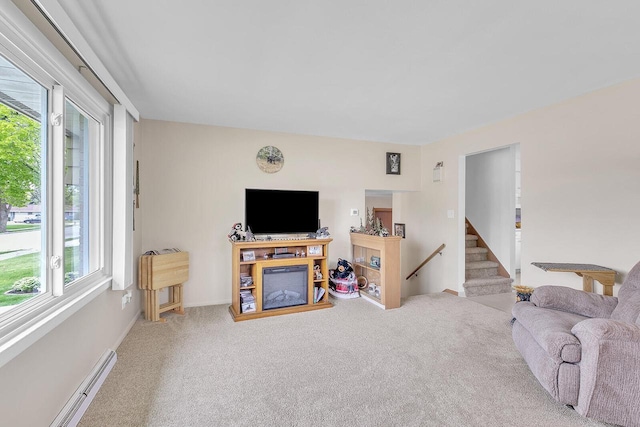 2117 N 27th St, Sheboygan, WI 53081 - carpeted living room with a baseboard heating unit, stairs, and baseboards