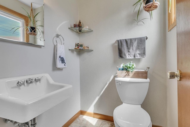 2117 N 27th St, Sheboygan, WI 53081 - half bath with a sink, toilet, and baseboards