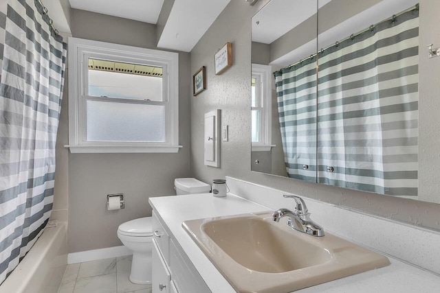 2117 N 27th St, Sheboygan, WI 53081 - full bathroom with vanity, toilet, baseboards, shower / bath combo with shower curtain, and marble finish floors
