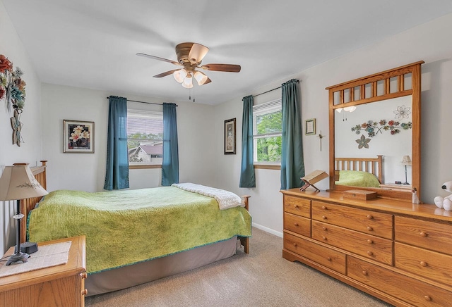 2117 N 27th St, Sheboygan, WI 53081 - carpeted bedroom featuring multiple windows, baseboards, and ceiling fan