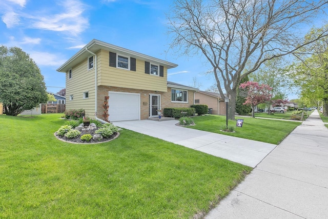 2117 N 27th St, Sheboygan, WI 53081 - split level home with an attached garage, a front yard, driveway, and brick siding